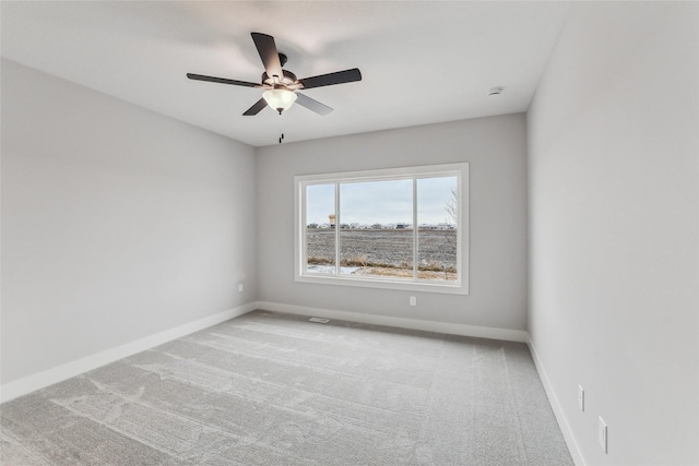 spare room with carpet flooring and ceiling fan