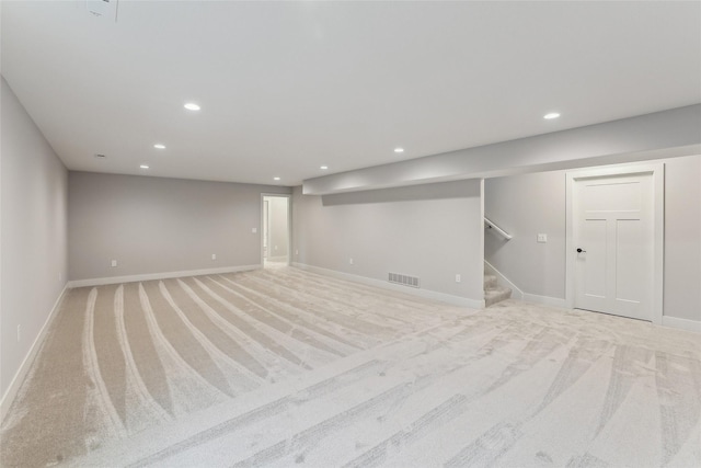 basement featuring light carpet