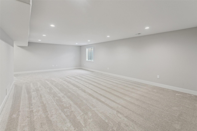 basement featuring light colored carpet