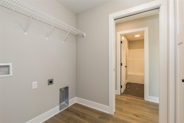 laundry room featuring hardwood / wood-style floors, electric dryer hookup, and washer hookup