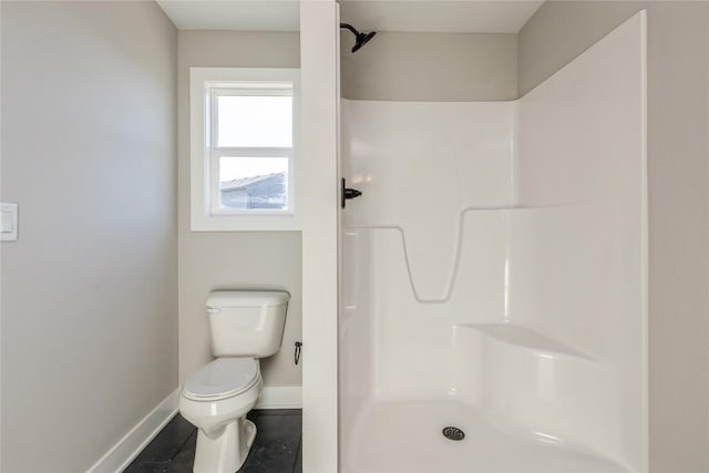 bathroom with tile patterned flooring, toilet, and walk in shower