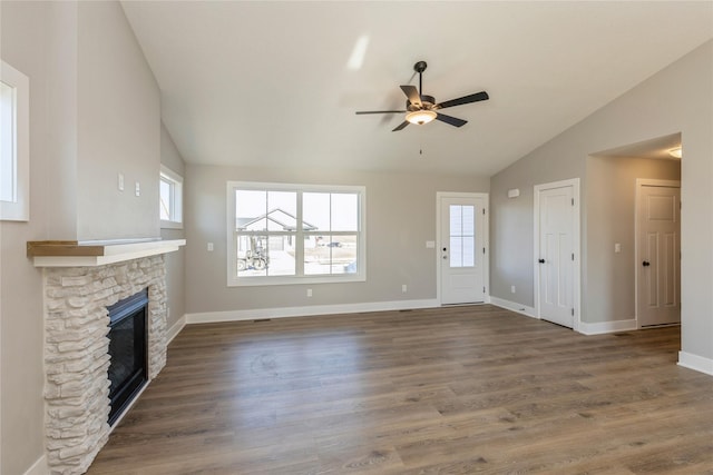 unfurnished living room featuring ceiling fan, a fireplace, dark wood-type flooring, and vaulted ceiling