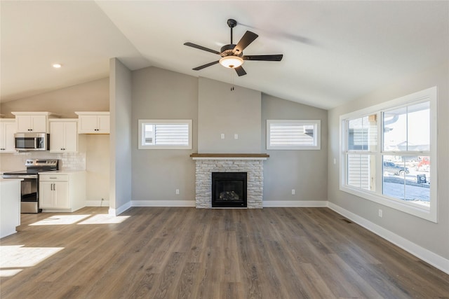 unfurnished living room with a fireplace, ceiling fan, dark hardwood / wood-style flooring, and lofted ceiling