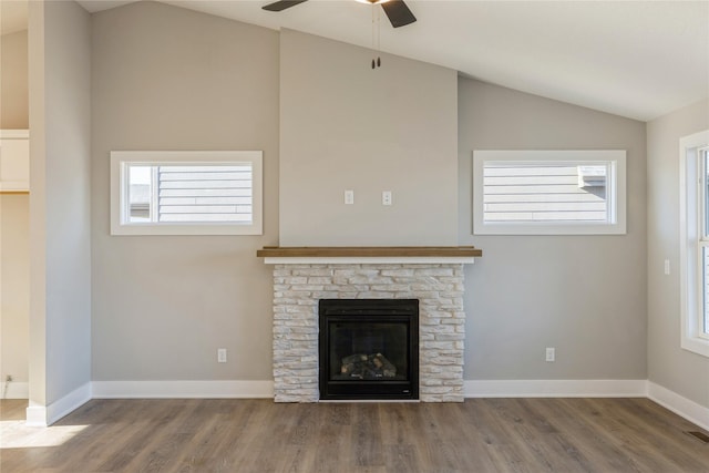 unfurnished living room with ceiling fan, a fireplace, lofted ceiling, and hardwood / wood-style flooring