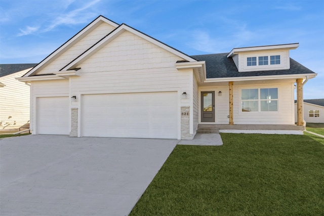 view of front of property with a garage and a front lawn