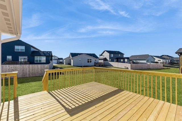 wooden deck featuring a lawn