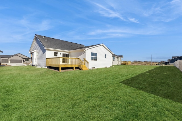 back of house featuring a yard and a wooden deck