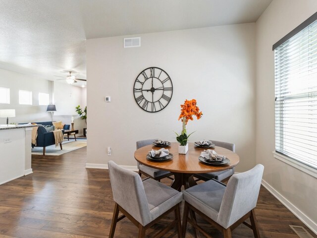 dining room with ceiling fan and dark hardwood / wood-style flooring