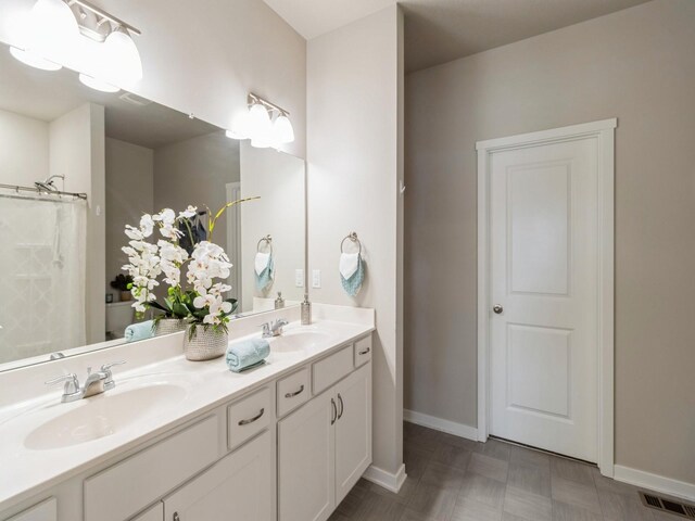 bathroom featuring vanity and curtained shower