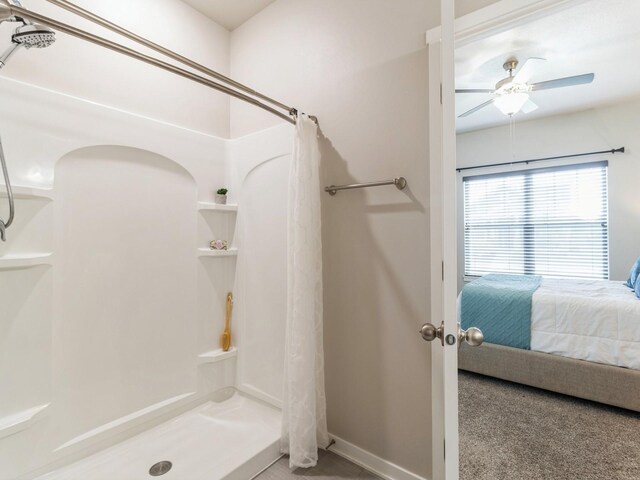 bathroom with ceiling fan and curtained shower