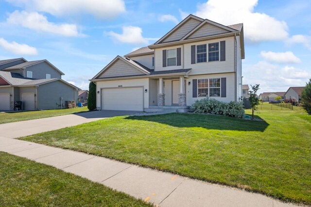 view of front of house featuring a garage and a front lawn