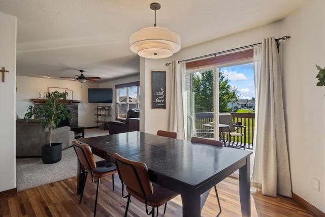 dining room with ceiling fan, baseboards, and wood finished floors