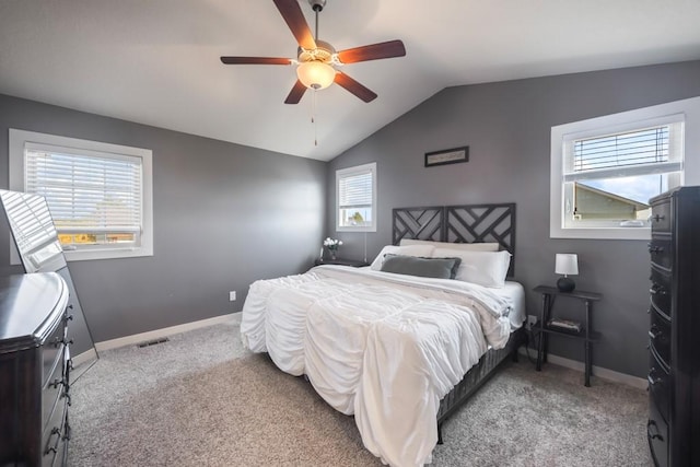 carpeted bedroom with a ceiling fan, visible vents, vaulted ceiling, and baseboards