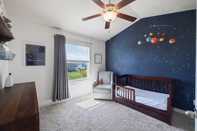 bedroom featuring an accent wall, carpet flooring, baseboards, vaulted ceiling, and wallpapered walls