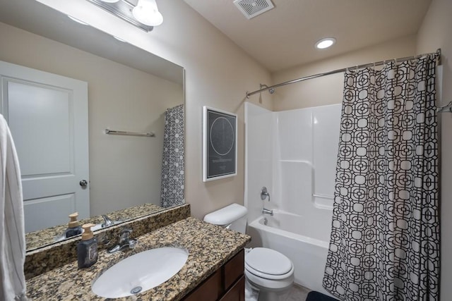 bathroom featuring toilet, shower / bath combo, vanity, and visible vents