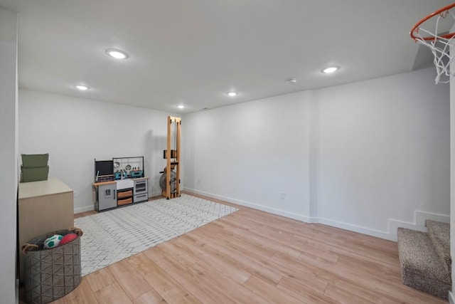 interior space featuring baseboards, light wood-type flooring, and recessed lighting