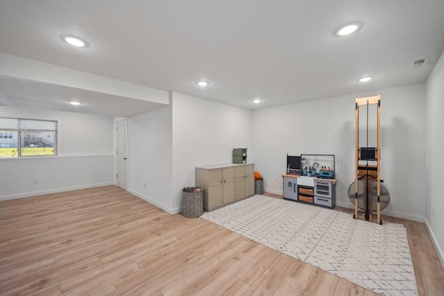 interior space featuring visible vents, baseboards, wood finished floors, and recessed lighting