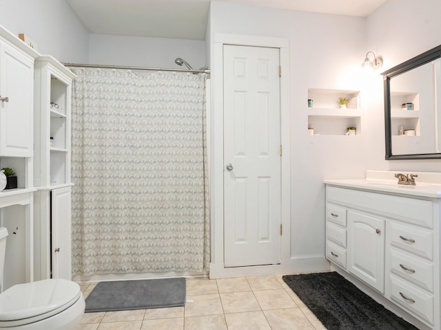 full bath with a shower with shower curtain, vanity, toilet, and tile patterned floors