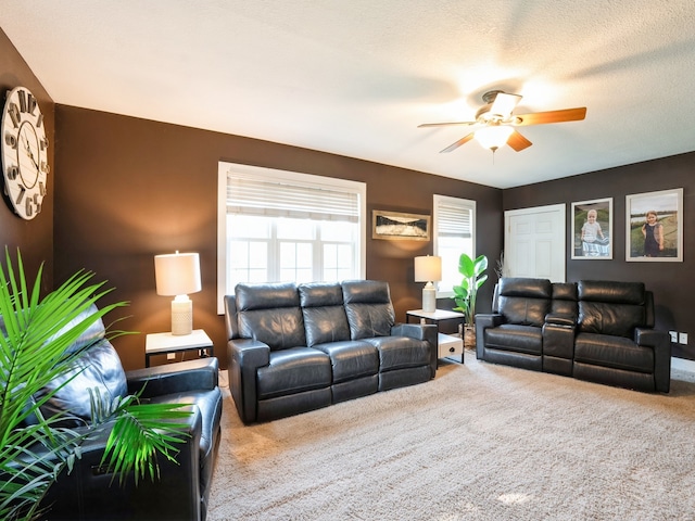 carpeted living room with a textured ceiling and a ceiling fan