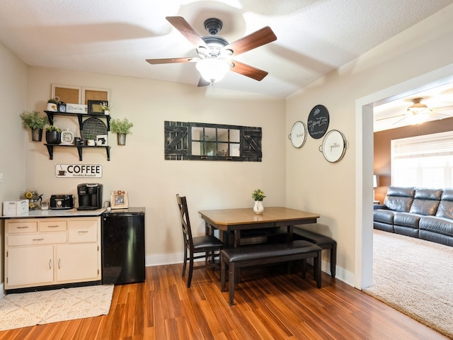 dining area featuring baseboards, ceiling fan, and light wood-style floors