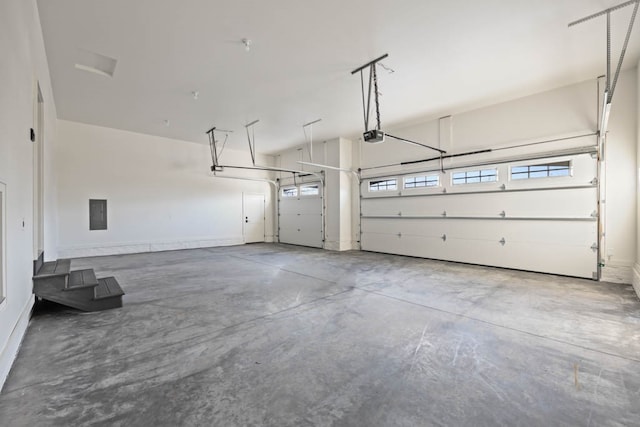 garage featuring electric panel and a garage door opener