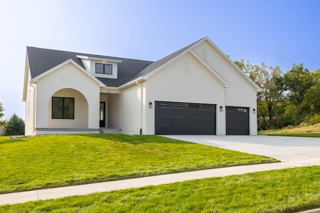 view of front of home with a garage and a front yard