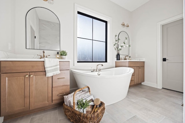 bathroom featuring vanity and a tub