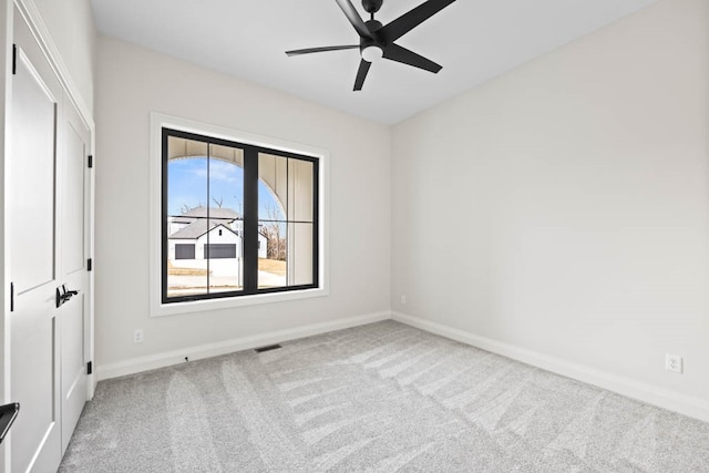 empty room with ceiling fan and carpet floors