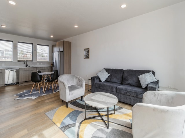 living room with recessed lighting and light wood-style flooring