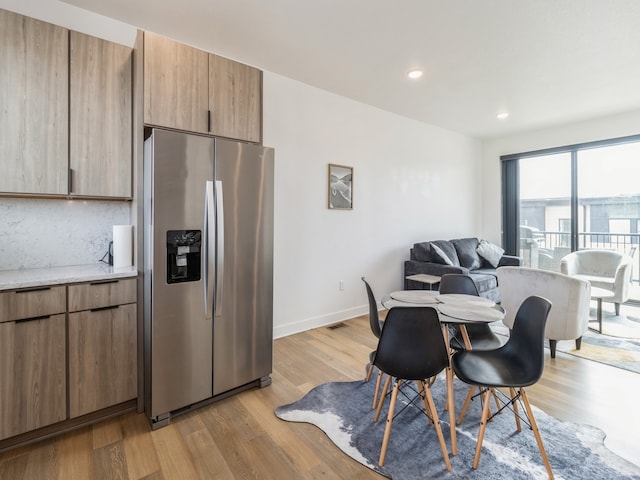 dining area featuring recessed lighting, light wood-style flooring, and baseboards