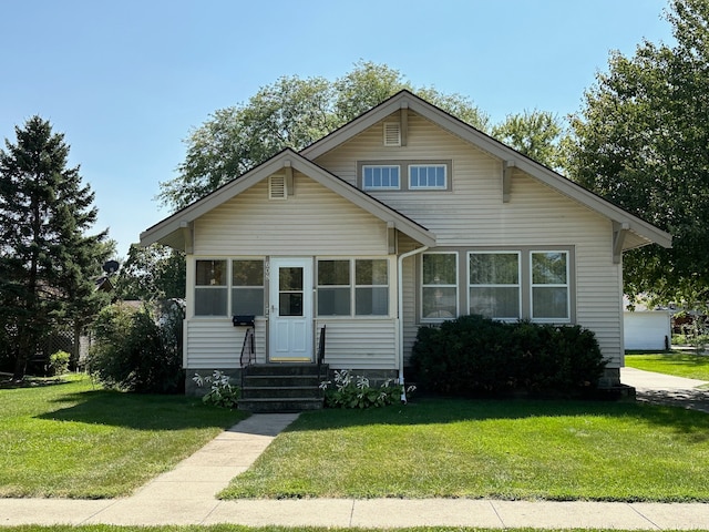 bungalow-style home with a front yard