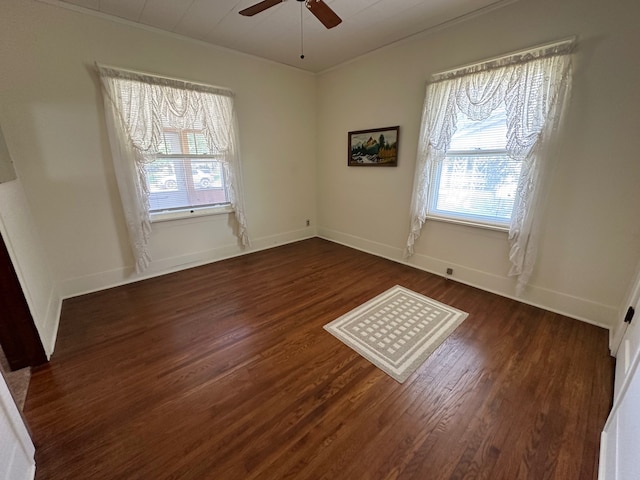 empty room featuring crown molding, dark hardwood / wood-style flooring, and ceiling fan