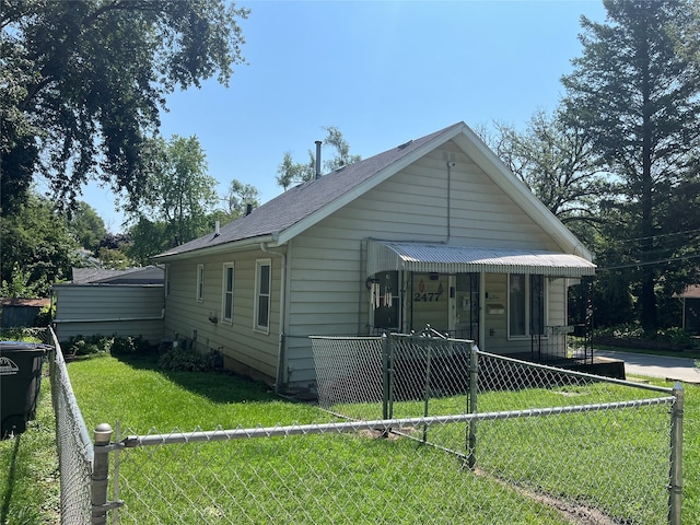 bungalow-style house with a front lawn and covered porch