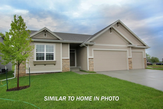 craftsman-style house featuring a garage and a front lawn