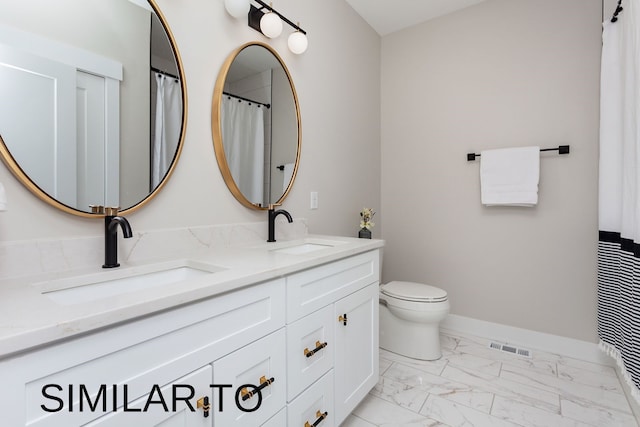 bathroom featuring vanity and toilet