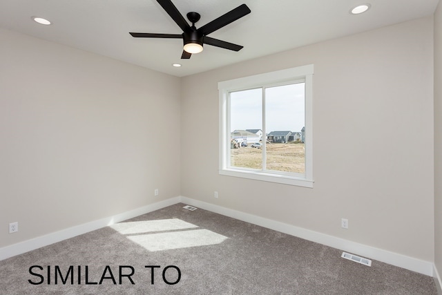 carpeted spare room featuring ceiling fan