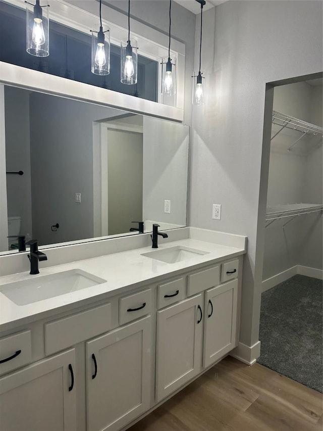 bathroom with hardwood / wood-style floors and vanity