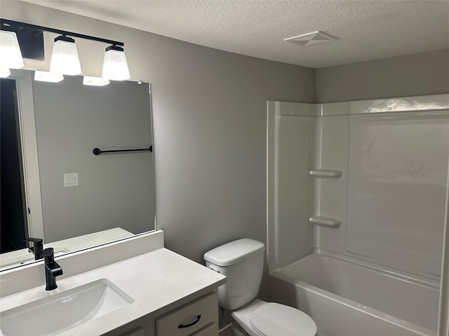 full bathroom with vanity, a textured ceiling, toilet, and shower / washtub combination