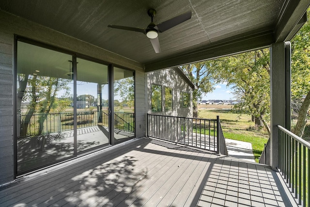 wooden deck with a ceiling fan
