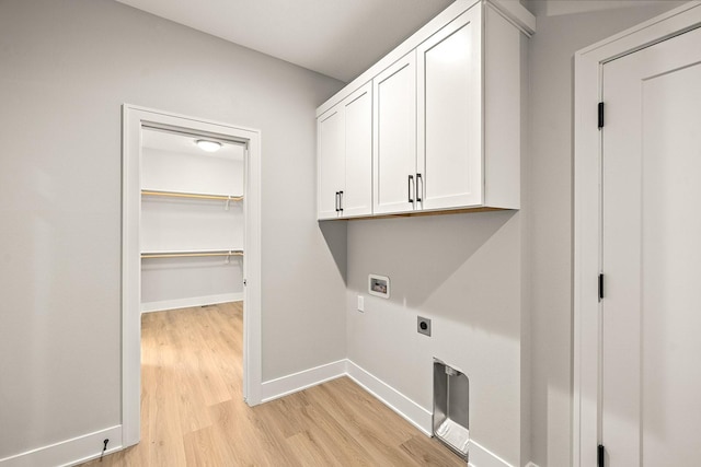 clothes washing area featuring hookup for an electric dryer, hookup for a washing machine, baseboards, cabinet space, and light wood-style flooring