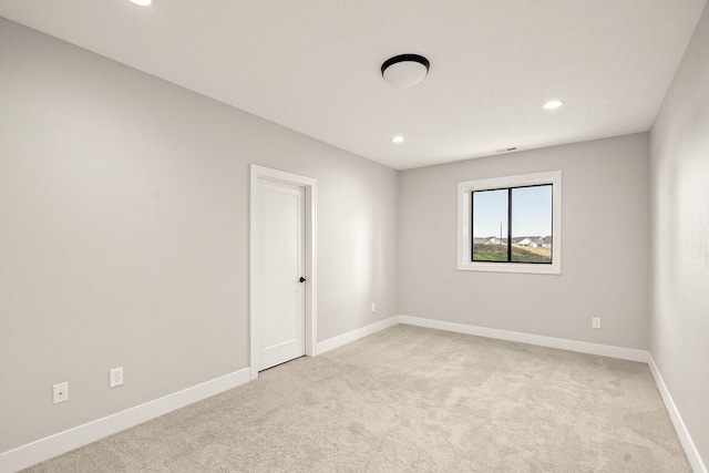 unfurnished room featuring baseboards, recessed lighting, and light colored carpet