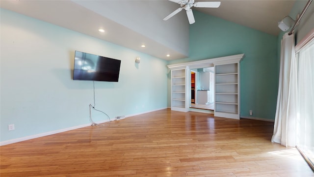 unfurnished living room with vaulted ceiling, plenty of natural light, ceiling fan, and light hardwood / wood-style floors