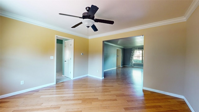 unfurnished room with light wood finished floors, baseboards, a ceiling fan, and ornamental molding