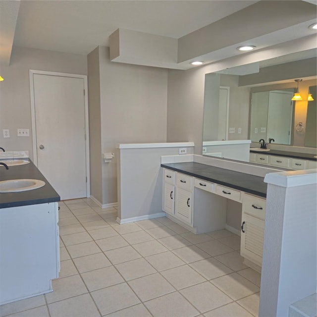 bathroom with tile patterned flooring, vanity, and baseboards