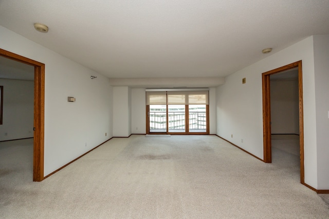 unfurnished room with light colored carpet