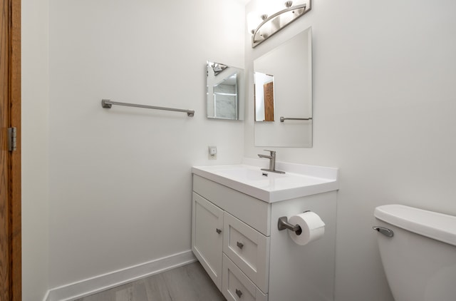 bathroom featuring vanity, toilet, and wood-type flooring