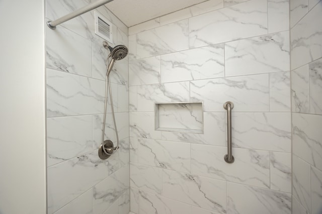 bathroom featuring tiled shower