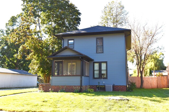 exterior space featuring a front yard and central AC unit