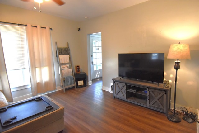 living room featuring ceiling fan, wood finished floors, and a healthy amount of sunlight