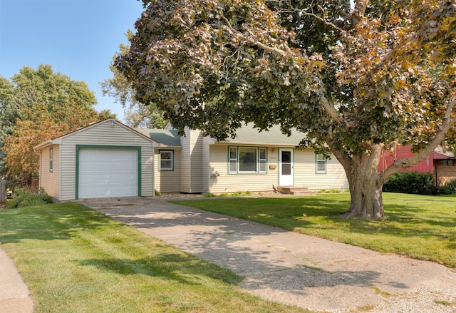 view of front of house featuring a garage and a front lawn